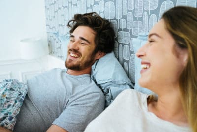 Young happy couple, waking up in the morning.