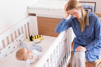 Mother trying to put her baby to sleep