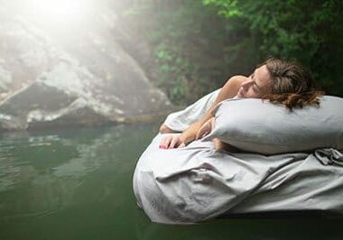 A hidden place. Sleeping woman in deep forest lies on airbed