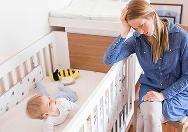 Mother trying to put her baby to sleep