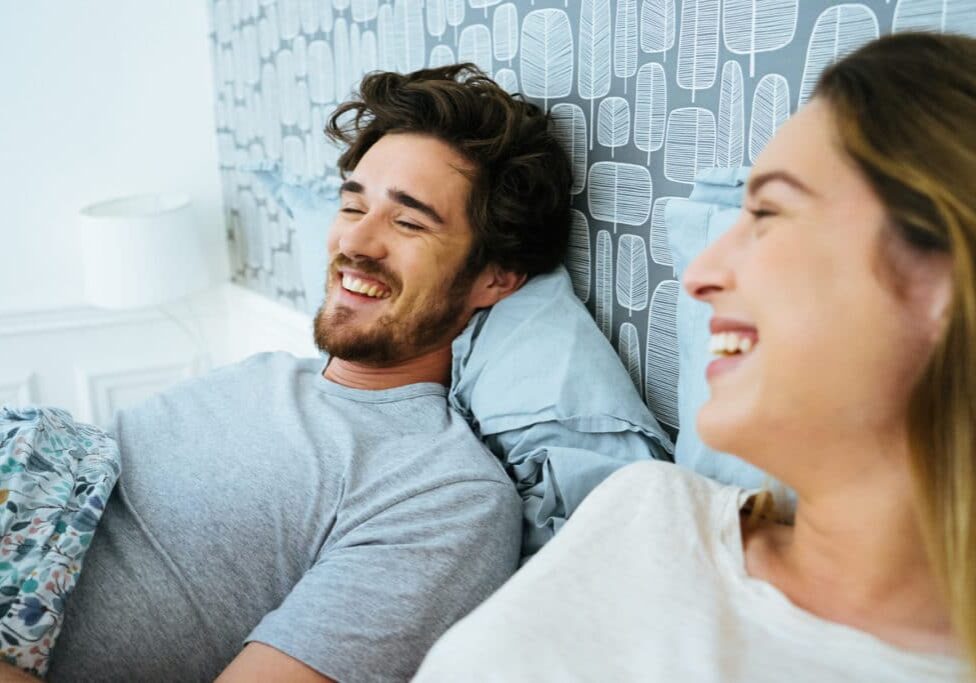 Young happy couple, waking up in the morning.