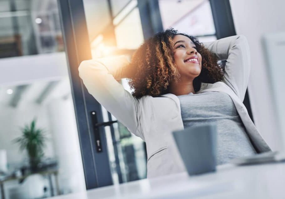 Shot of a young businesswoman taking a break at her office desk